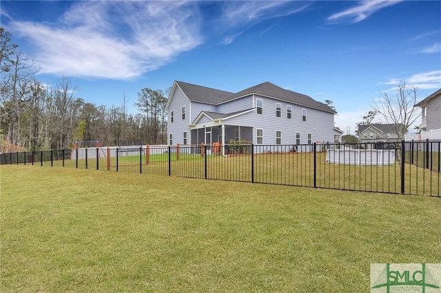 view of yard with a sunroom and a swimming pool