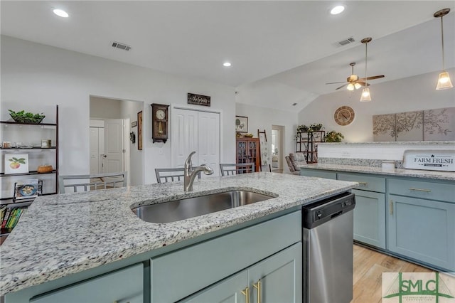 kitchen featuring ceiling fan, sink, stainless steel dishwasher, lofted ceiling, and light wood-type flooring