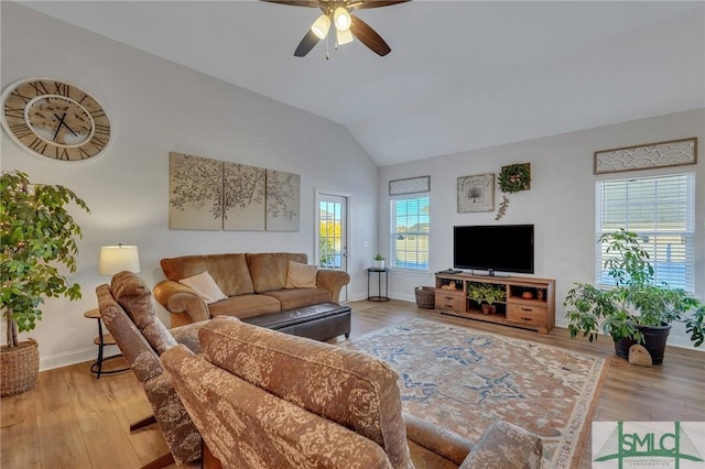 living room with light hardwood / wood-style floors, vaulted ceiling, and ceiling fan