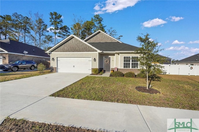 view of front of property featuring a garage and a front lawn