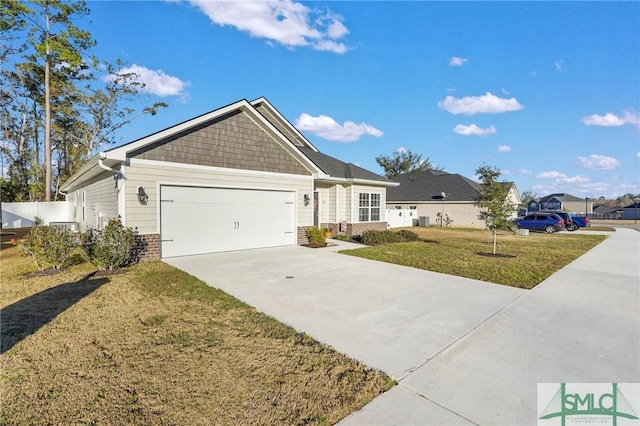 view of front of property featuring a front lawn and a garage