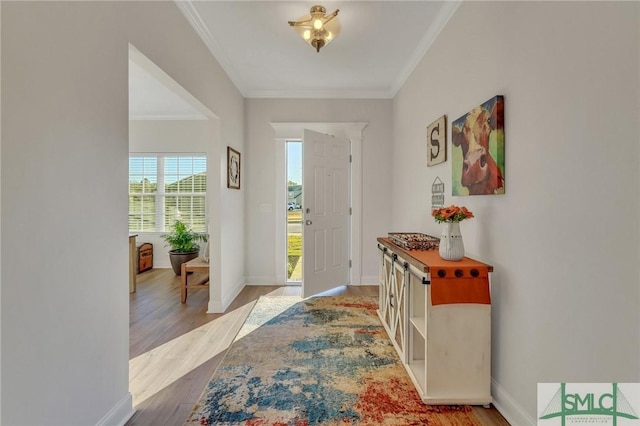 foyer entrance featuring ornamental molding and light hardwood / wood-style flooring