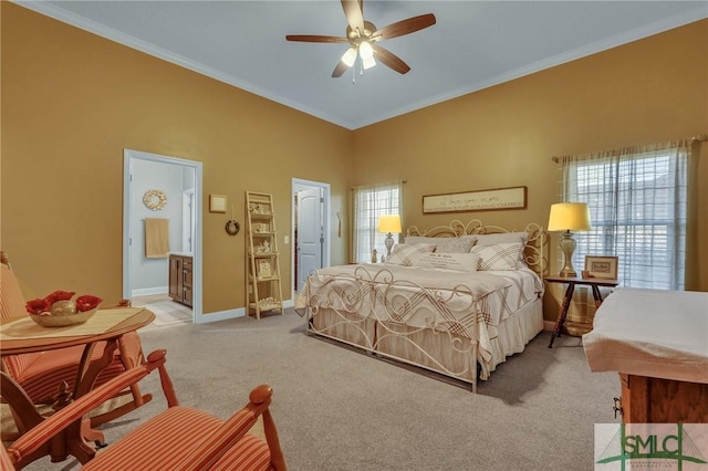 carpeted bedroom featuring ensuite bath, ceiling fan, and crown molding