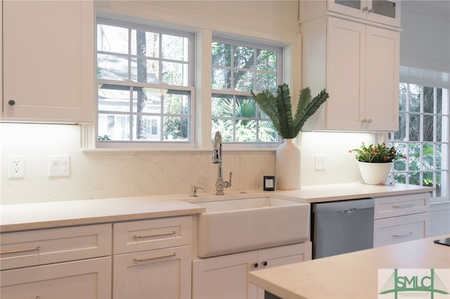 kitchen with white cabinets, dishwasher, and sink