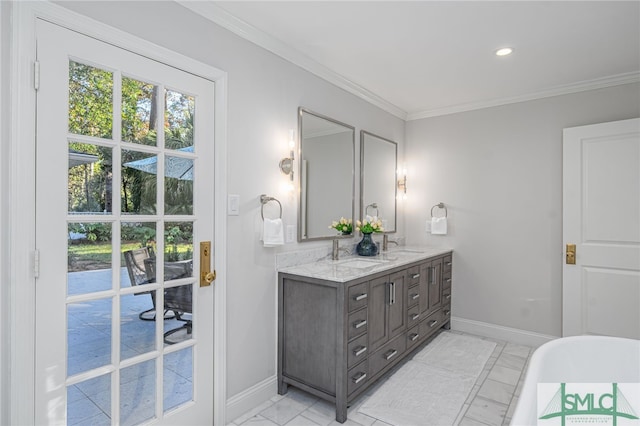 bathroom with a washtub, vanity, and crown molding