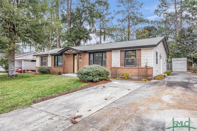 ranch-style house with a front yard and an outbuilding