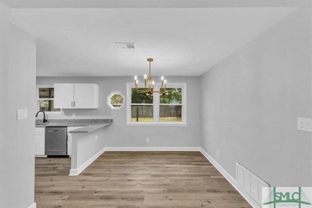 kitchen with white cabinets, dishwasher, pendant lighting, and a wealth of natural light