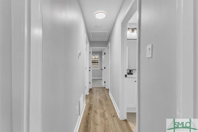 hallway with light hardwood / wood-style floors