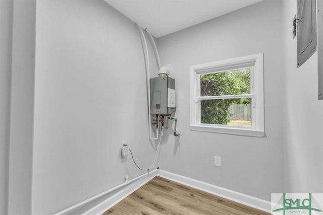 washroom featuring tankless water heater and light hardwood / wood-style floors