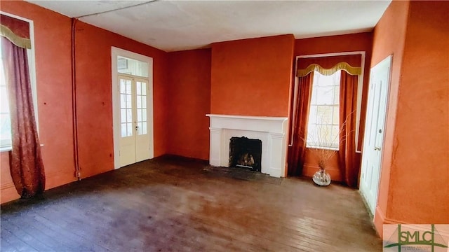 unfurnished living room with french doors and dark hardwood / wood-style floors