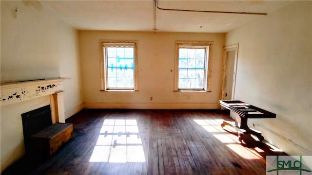 unfurnished living room featuring dark wood-type flooring