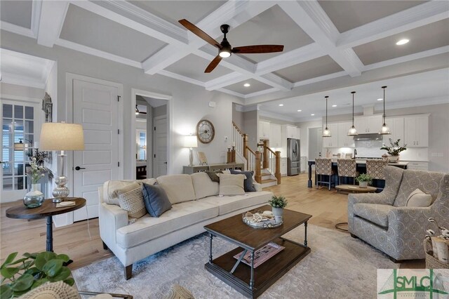 living room with ceiling fan, crown molding, beamed ceiling, and coffered ceiling