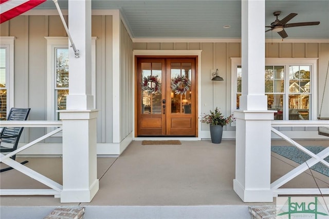 entrance to property featuring ceiling fan, a porch, and french doors