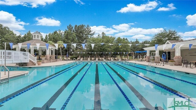 view of swimming pool with a gazebo and a patio