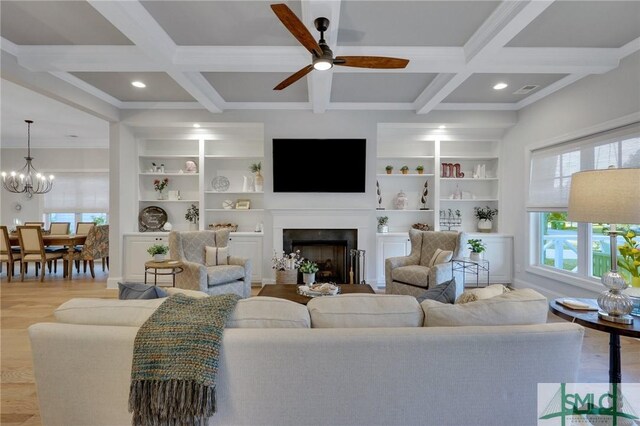 living room featuring beam ceiling, built in shelves, and coffered ceiling