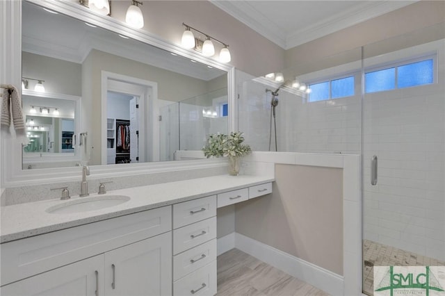 bathroom with ornamental molding, vanity, and walk in shower