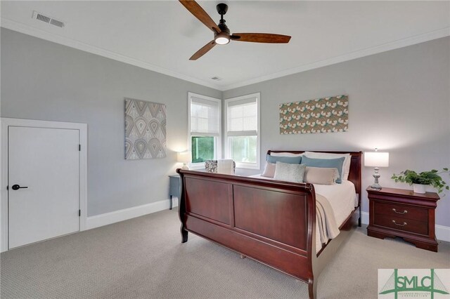 carpeted bedroom featuring ceiling fan and ornamental molding