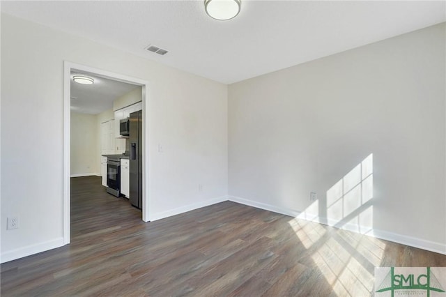 empty room featuring dark hardwood / wood-style flooring