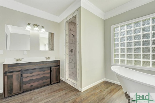 bathroom with hardwood / wood-style flooring, vanity, ornamental molding, and shower with separate bathtub