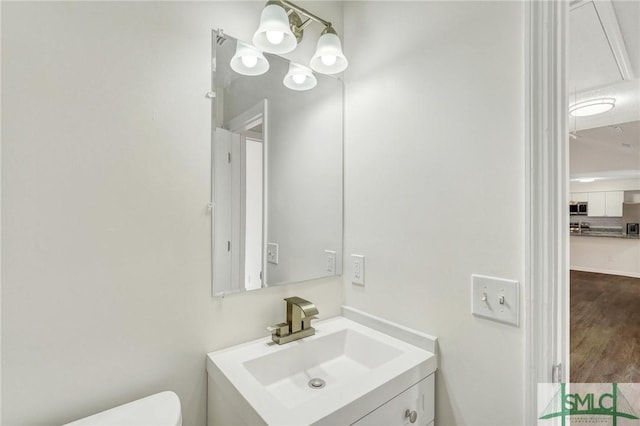 bathroom with vanity and toilet