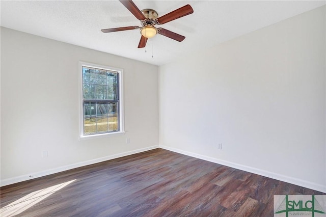 spare room with ceiling fan and dark wood-type flooring