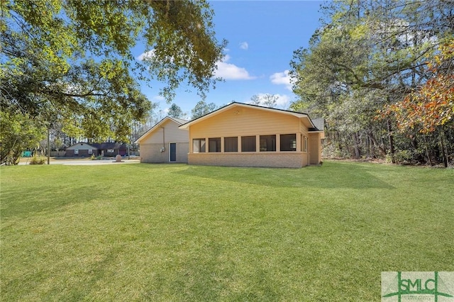 back of house featuring a lawn