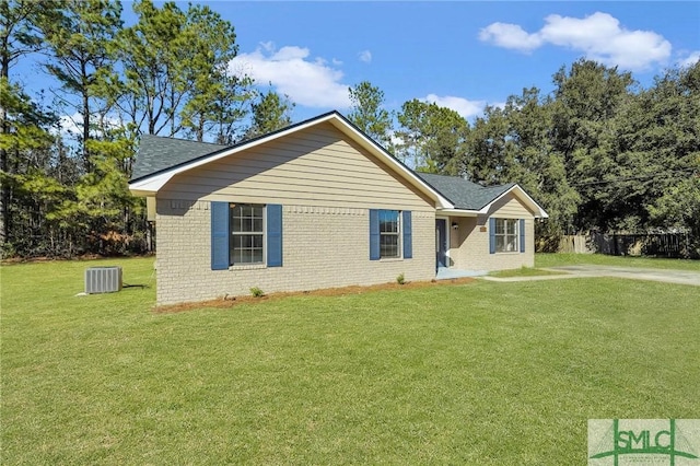 view of front of house with central AC and a front lawn