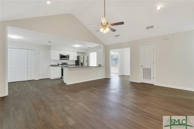 unfurnished living room with dark hardwood / wood-style floors, high vaulted ceiling, and ceiling fan