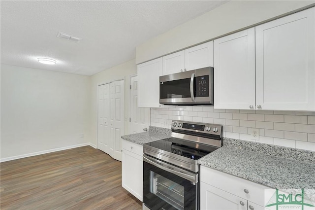 kitchen with white cabinetry, a textured ceiling, and appliances with stainless steel finishes