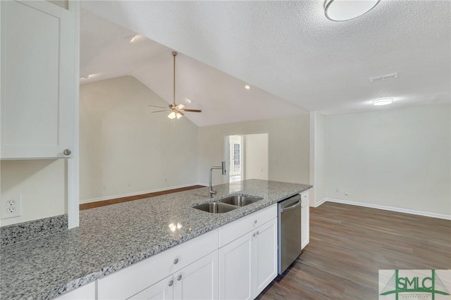 kitchen with light stone counters, dishwasher, white cabinets, and sink