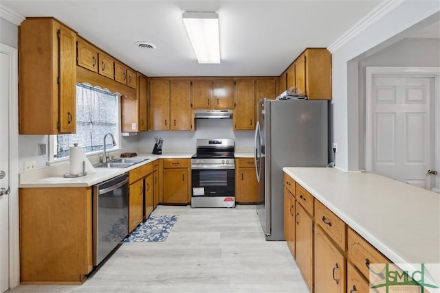 108 Dawson Ln, Ludowici, GA 31316 - kitchen featuring stainless steel appliances, light hardwood / wood-style flooring, ornamental molding, and sink