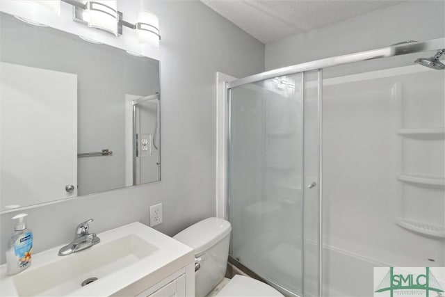 108 Dawson Ln, Ludowici, GA 31316 - bathroom with a textured ceiling, vanity, toilet, and walk in shower