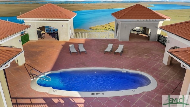 view of pool with a gazebo and an outdoor bar