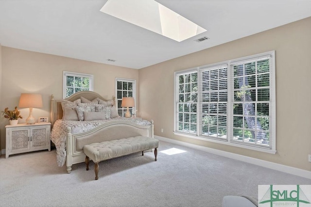 carpeted bedroom featuring a skylight