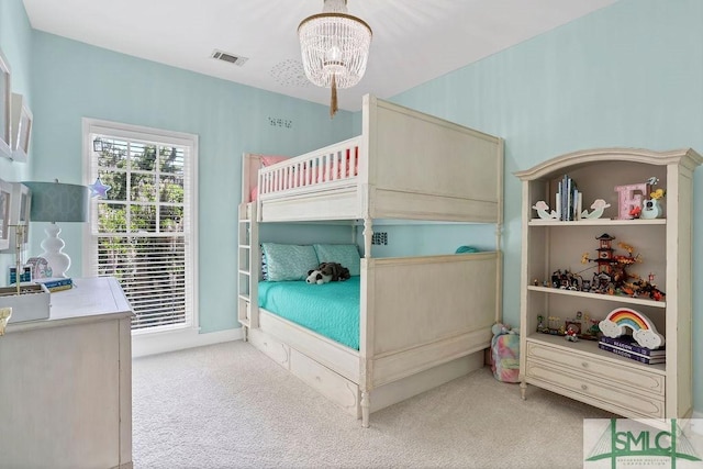 bedroom featuring light carpet and a notable chandelier