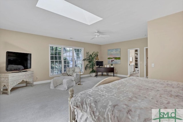 carpeted bedroom with a skylight and ceiling fan