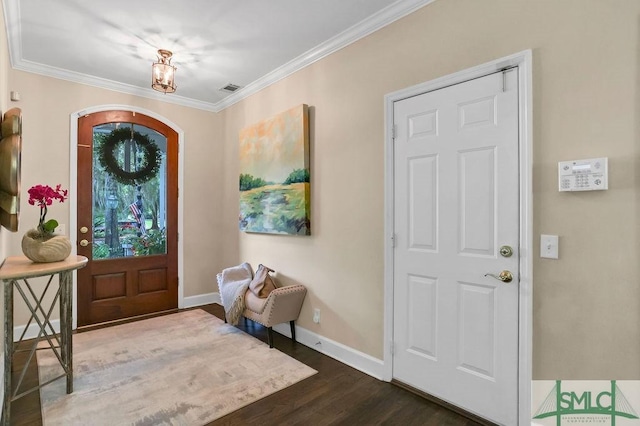 foyer featuring dark hardwood / wood-style floors and crown molding