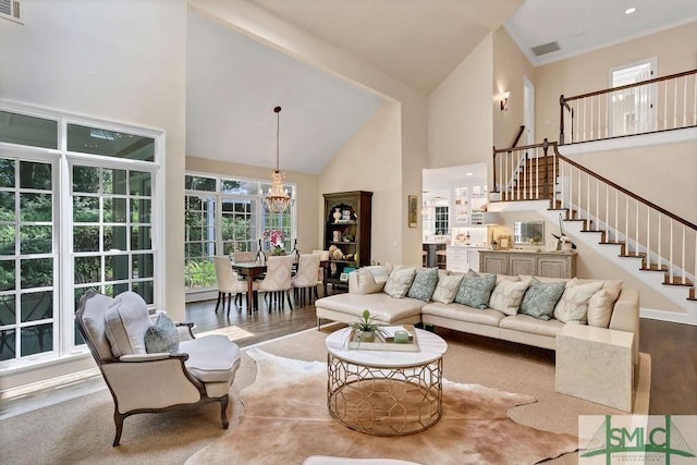 living room featuring a chandelier and high vaulted ceiling