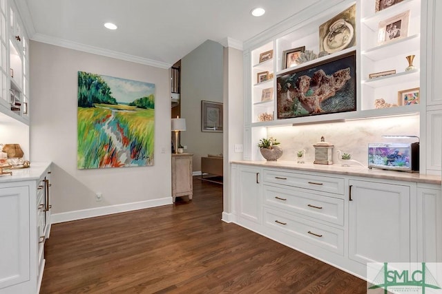 interior space featuring dark hardwood / wood-style flooring, white cabinetry, and crown molding