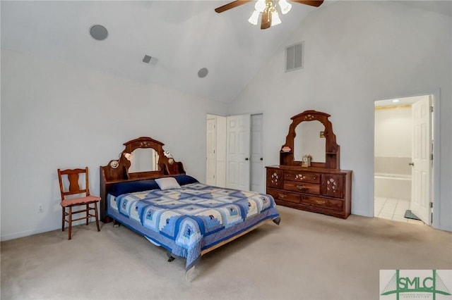 carpeted bedroom featuring ceiling fan, ensuite bathroom, and high vaulted ceiling