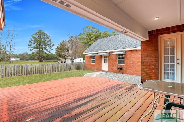 wooden deck with a lawn