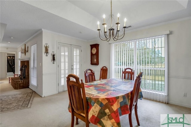 carpeted dining area featuring a brick fireplace, a notable chandelier, and crown molding