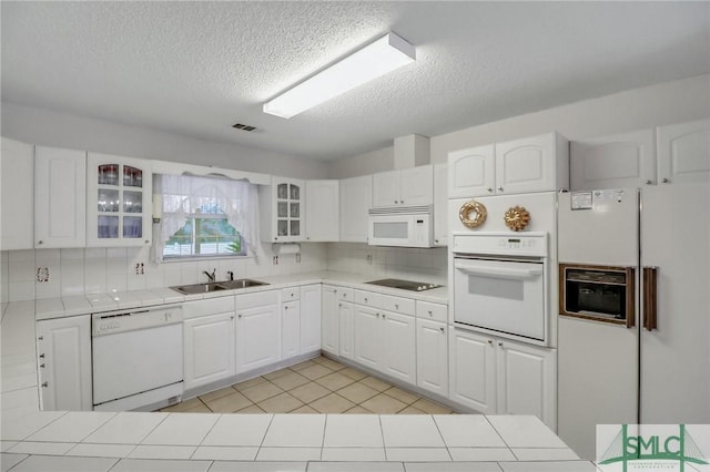 kitchen featuring white cabinets and white appliances