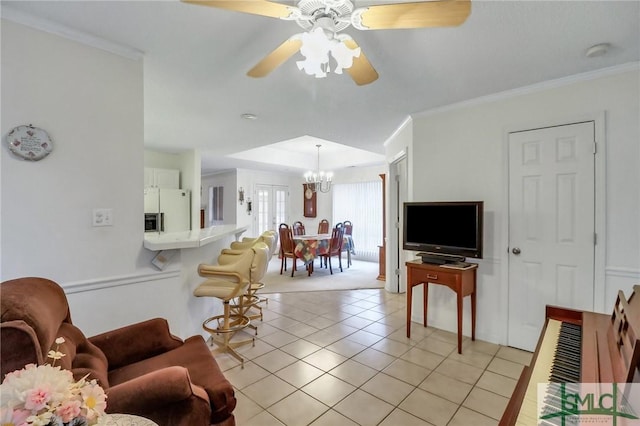 living room featuring ceiling fan with notable chandelier, ornamental molding, and light tile patterned floors