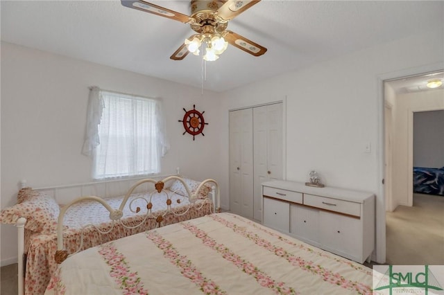 bedroom with ceiling fan, a closet, and carpet