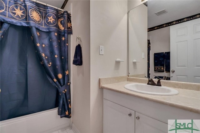 bathroom featuring shower / bath combination with curtain, vanity, and tile patterned floors