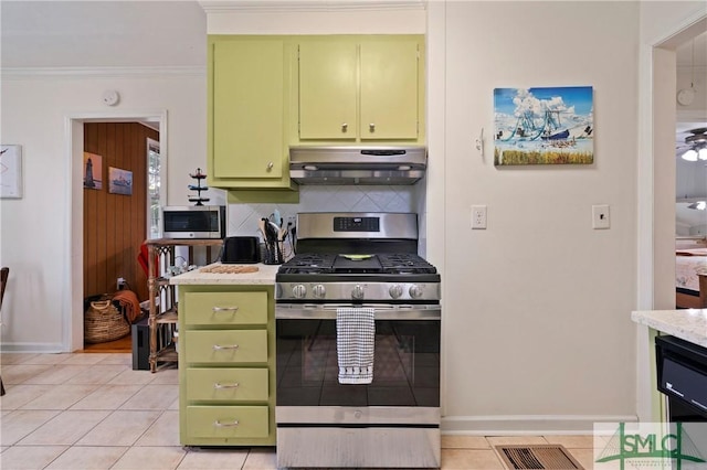 kitchen featuring green cabinets, light tile patterned floors, and appliances with stainless steel finishes