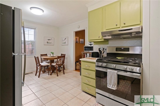 kitchen featuring green cabinets, light tile patterned floors, ornamental molding, and appliances with stainless steel finishes