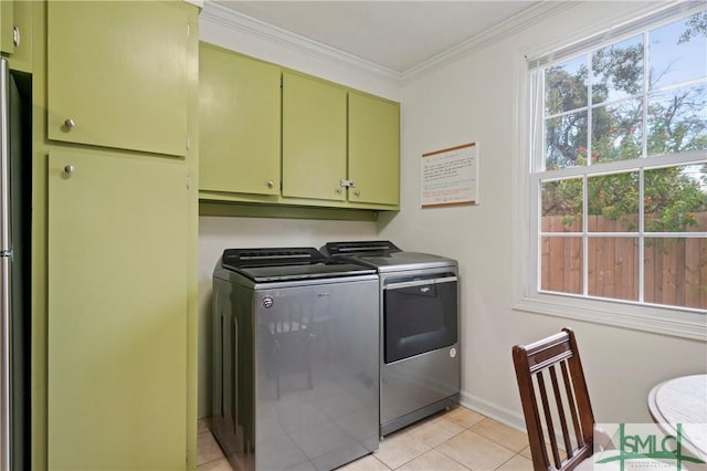 laundry room featuring cabinets, light tile patterned floors, washer and dryer, and ornamental molding