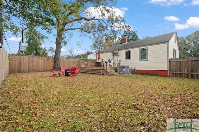 back of house featuring a yard, a deck, and cooling unit